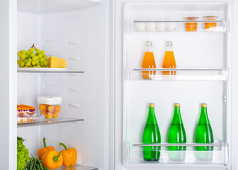 Open fridge full of fresh fruits and vegetables