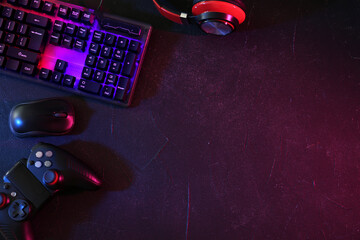 Modern RGB keyboard, mouse and video game controller on grey table, flat lay. Space for text © New Africa