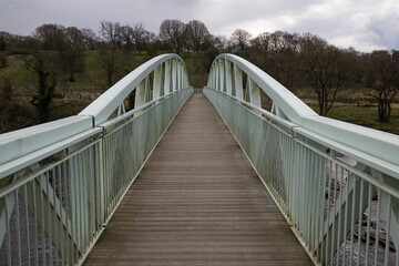 Dinkley footbridge crossing the river ribble near hurst green. Symmetrical metal footbridge