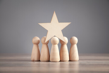 Wooden human figures with star. Best customer evaluation and satisfaction