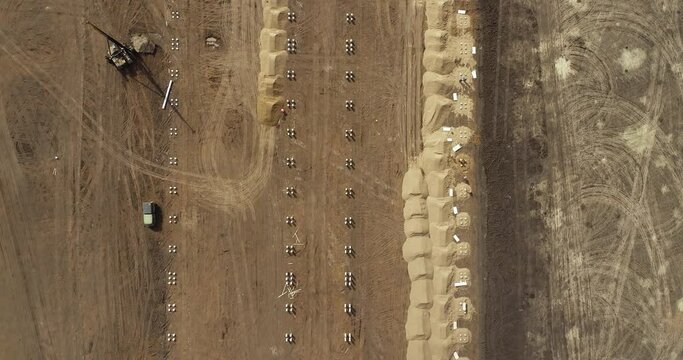 Equipment for installing piles in ground, heavy machines for driving pillars work in laying the foundation building. Construction aerial view height.