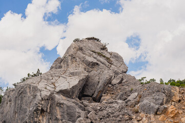 Rock mountain in front of blue cloudy sky. Beautiful landscape