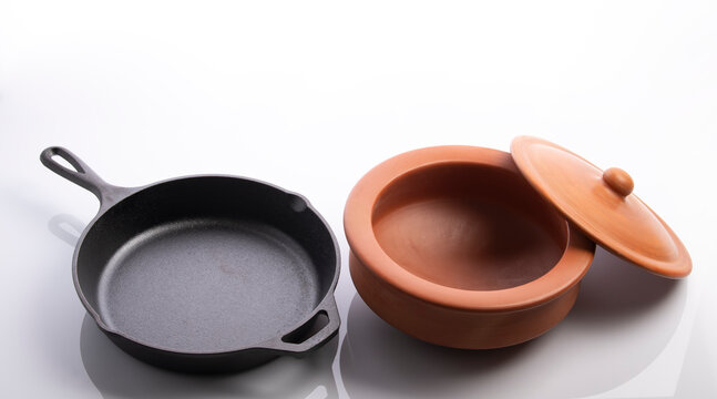 Cast Iron Skillet and Clay Pots Isolated on White Background