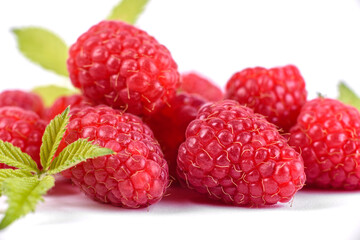 Ripe raspberries with raspberry leaf isolated on a white background