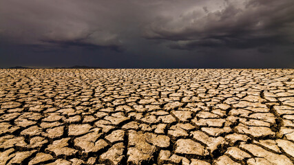 The earth is in cracks and clouds, as if something bad is coming