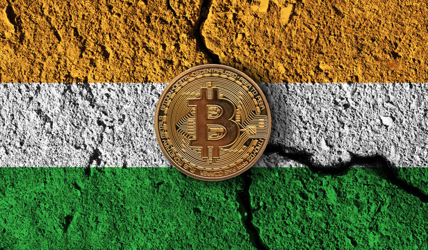 Bitcoin crypto currency coin with cracked India flag. Crypto restrictions - Powered by Adobe