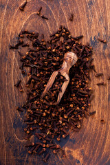 Cloves. Dry seasoning for cooking and drinks on a simple old wooden background. Selective focus