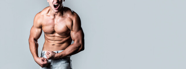 Muscular male strains muscles and screams. Muscular bodybuilder posing over white background....