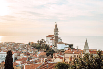 A panoramic of old town Piran, Slovenia at sunset. View over the tiled roofs of Piran and the Adriatic Sea.