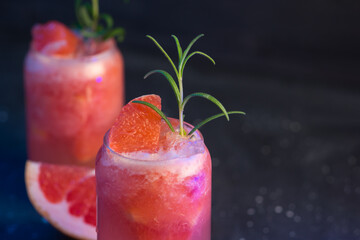 Close-up of two glasses of a refreshing summer cocktail with grapefruit and crushed ice