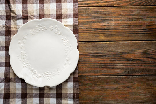 Overhead View Of Empty White Plate On Wooden Table