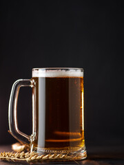 A mug of light beer on a black background