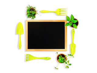 There is a black inscription board in the center of the white sheet. Garden items are located...