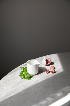 Garlic and parsley near sauce boat
