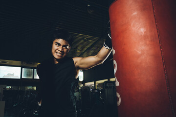 Asian male training boxing in the gym