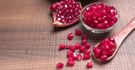 Fototapeta na wymiar Fresh Pomegranate, rich in natural antioxidants. Concept of red fruits, vitamins and natural antioxidants to the skin for beauty.