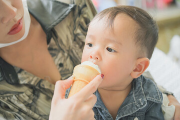 Sweet toddler boy eating ice cream