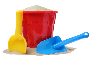 Plastic toy bucket with colorful shovels and sand on white background - obrazy, fototapety, plakaty