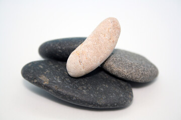 Fototapeta na wymiar Sea round stones on a white background. Selective focus.