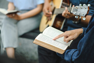 Christian family groups holding hands praying with Holy Bible. and play guitar to sing worship...