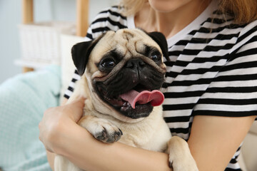 Woman with cute pug dog at home, closeup. Animal adoption - Powered by Adobe