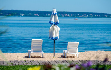 Obraz premium Sun loungers and umbrellas are on the beach