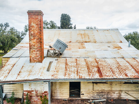 Looking down on the rusting rooftop of an abandoned farmhouse