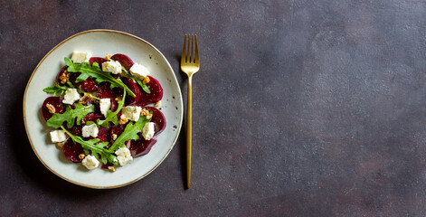 Obraz na płótnie Canvas Beetroot salad with cheese, arugula, nuts and honey. Healthy eating. Vegetarian food.