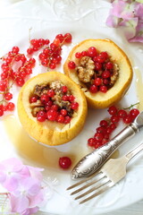 Baked apples with honey, walnuts, currants on a white background
