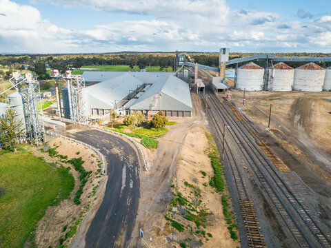 Looking down on roads and railways lines running to a collection of grain silos