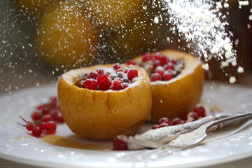 Baked apples with honey, walnuts, currants on a white background
