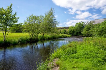 Fototapeta na wymiar River Doon flowing through the Ayrshire village of Dalrymple