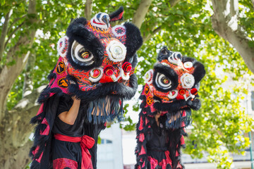 Twin Chinese Dragons dancing in a parade