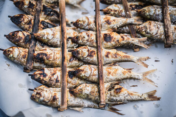 Freshwater fish wrapped in bamboo and grilled with wooden shavings are sold at the Yasothon...
