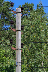 The upper part of the support of a high-voltage power line on a summer day