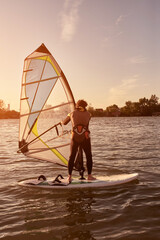 Naklejka premium Windsurfer surfing on a windy day at the river.