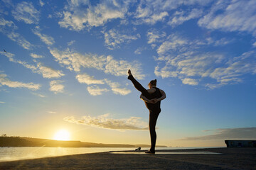 spectacular backlit image of an outdoor yoga pose