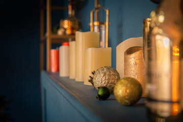 Large candles and Christmas tree decorations over the fireplace