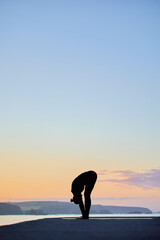 vertical image with large copy space of Caucasian woman practicing yoga