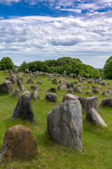 vertical view of the Viking burial grounds at Lindholm Hills under a blue sk with white clouds