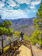 A young tourist at the Mirador Lomo de las Chozas de La Cumbrecita on the island of La Palma next to the Caldera de Taburiente, Canary Islands. Spain © unai