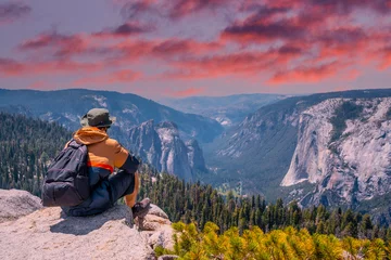 Fototapeten A young winged seated Taft point looking at Yosemite National Park and El Capitan in sunset. United States © unai
