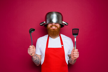 happy chef with beard and red apron is ready to cook