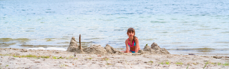 Fototapeta na wymiar Portrait of beautiful young girl playing on sea beach. Summer holiday, rest and vacation concept.
