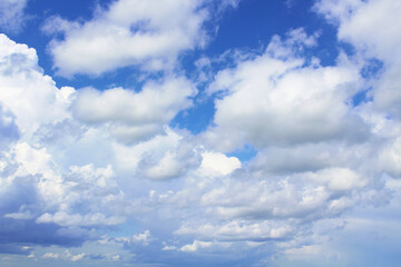 Beautiful blue sky and white cumulus clouds. Close-up. Background. Texture. Scenery.