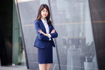 Fototapeta na wymiar Beautiful Asian woman outdoors, wearing a suit