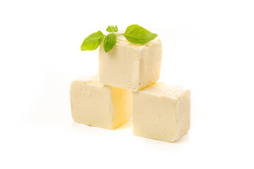 Pieces, cubes of yellow natural oil isolated on a white background.
