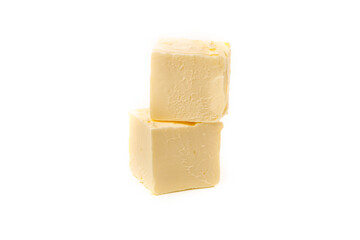 Pieces, cubes of yellow natural oil isolated on a white background.