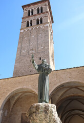bell tower of the cathedral and the statue of Saint Francis of Assisi in the city of Rieti in the Lazio region in central Italy without people - obrazy, fototapety, plakaty