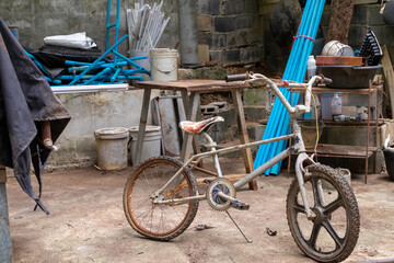 Fototapeta na wymiar Childhood bicycle, old storage, childhood memories